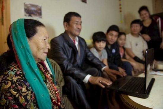 family looking at laptop