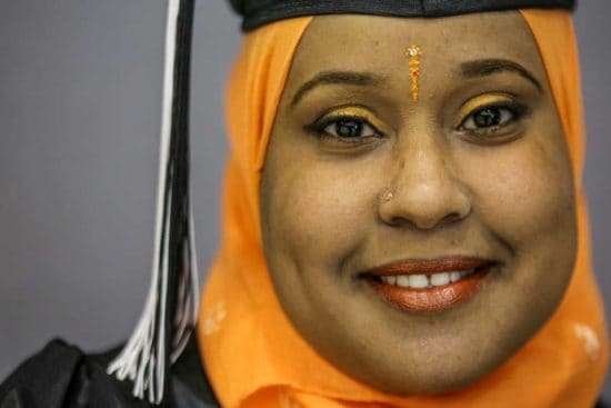 Adult female graduate wearing orange hijab