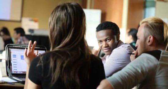 Wilson Kubwayo with other young people in classroom setting