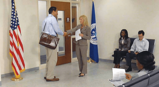 women greets man at naturalization test interview