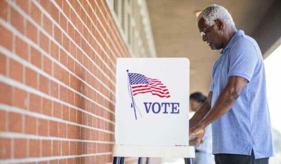 Man voting at a voting booth